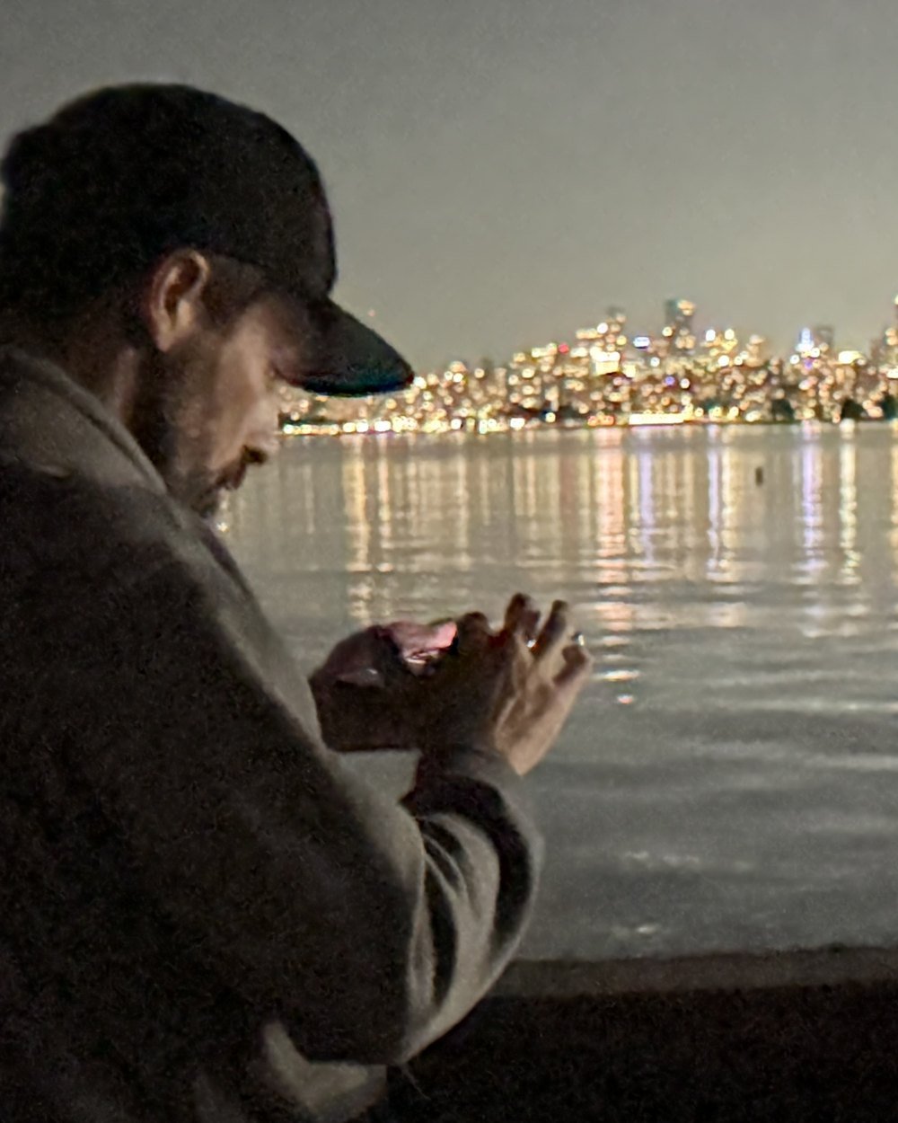Craig Becker across the water from the Vancouver skyline at night