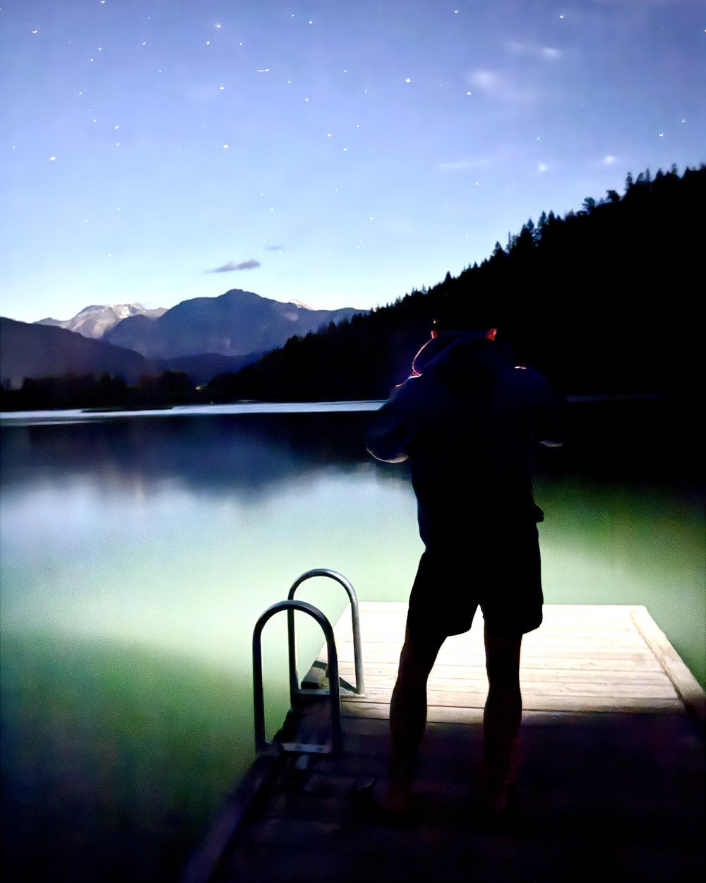 Craig Becker on a lake dock under a night sky